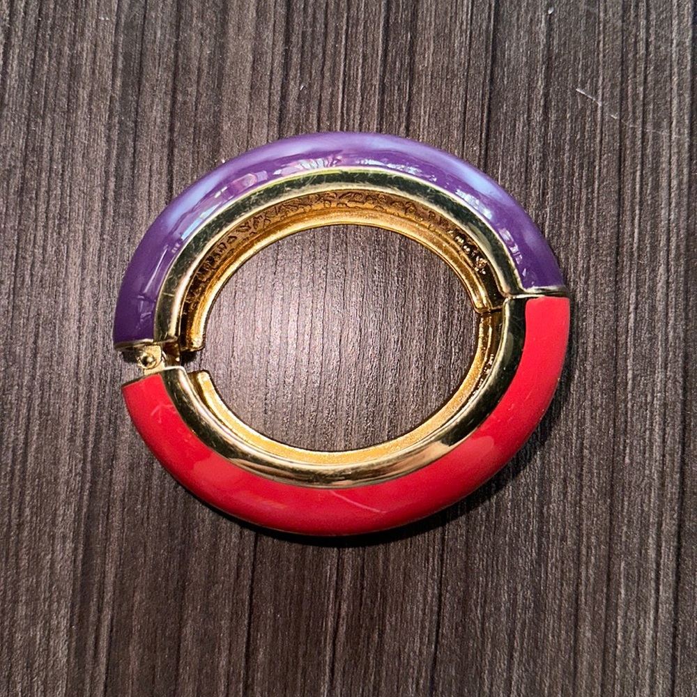 Pretty thick coral/purple and gold tone bangle. Self closing on a spring.